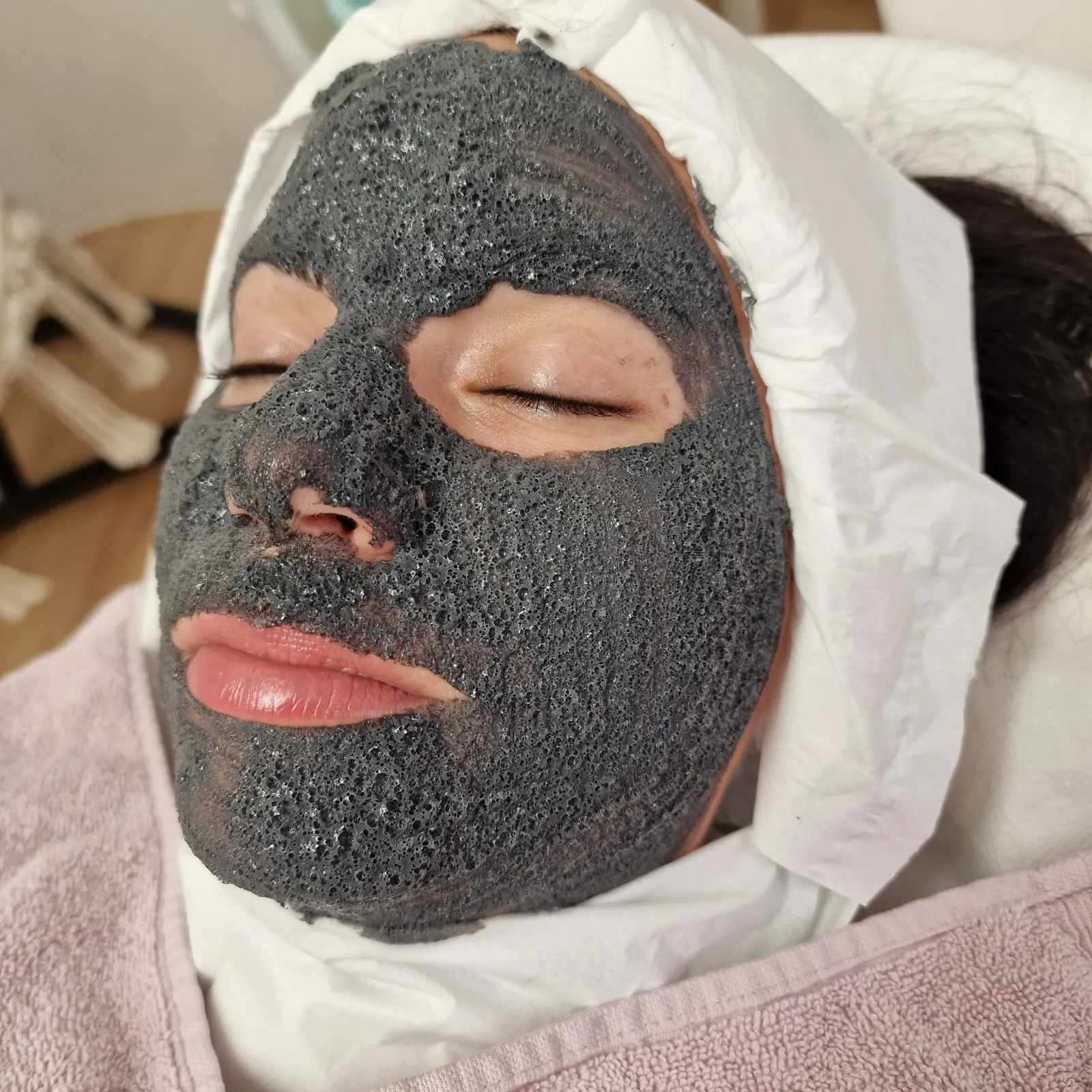 Gesichtsbehandlung mit schwarzer Maske
